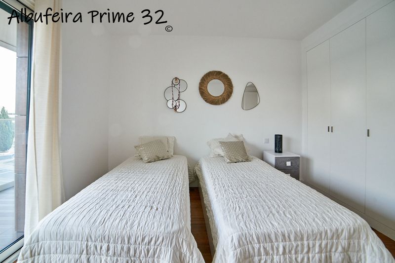 Third bedroom with two single beds and fitted wardrobes